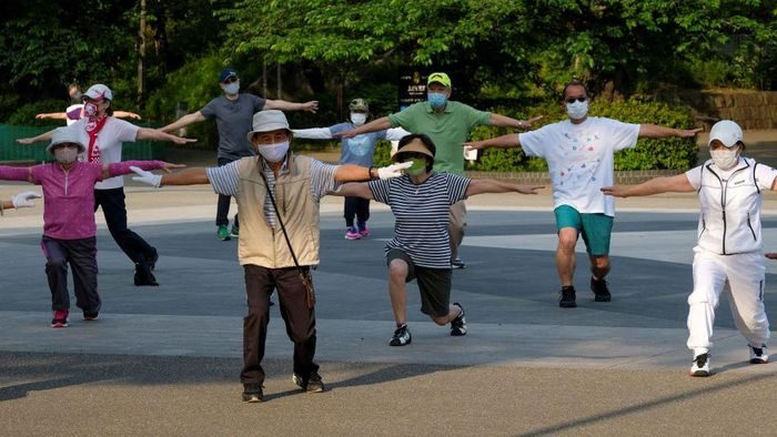 This picture taken on May 25, 2021 shows people taking part in a morning 'radio taiso' exercise at a park in Tokyo. - It might not make the cut for Olympians at Tokyo 2020, but each day in Japan's parks, schools and offices millions perform the country's most popular stretching routine: radio taiso.
- TO GO WITH Oly-2020-2021-Japan-health-exercise-virus-taiso,FOCUS by Ayaka McGill and Katie Forster (Photo by Kazuhiro NOGI / AFP) / TO GO WITH Oly-2020-2021-Japan-health-exercise-virus-taiso,FOCUS by Ayaka McGill and Katie Forster (Photo by KAZUHIRO NOGI/AFP via Getty Images) This picture taken on May 25, 2021 shows people taking part in a morning 'radio taiso' exercise at a park in Tokyo. - It might not make the cut for Olympians at Tokyo 2020, but each day in Japan's parks, schools and offices millions perform the country's most popular stretching routine: radio taiso.
- TO GO WITH Oly-2020-2021-Japan-health-exercise-virus-taiso,FOCUS by Ayaka McGill and Katie Forster (Photo by Kazuhiro NOGI / AFP) / TO GO WITH Oly-2020-2021-Japan-health-exercise-virus-taiso,FOCUS by Ayaka McGill and Katie Forster (Photo by KAZUHIRO NOGI/AFP via Getty Images)